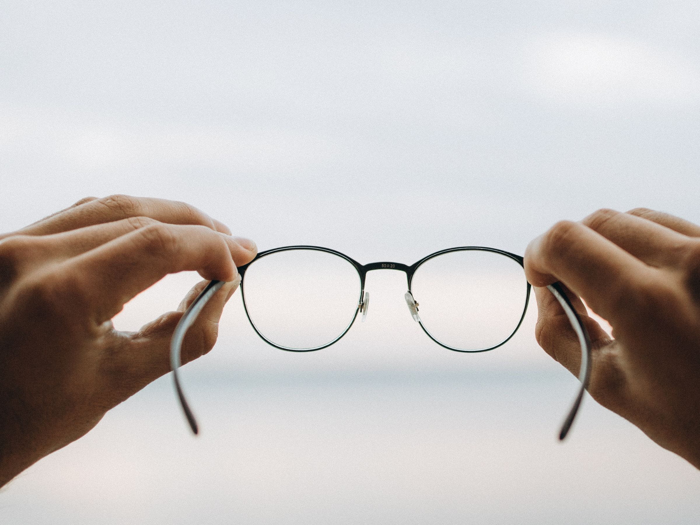 person holding up glasses