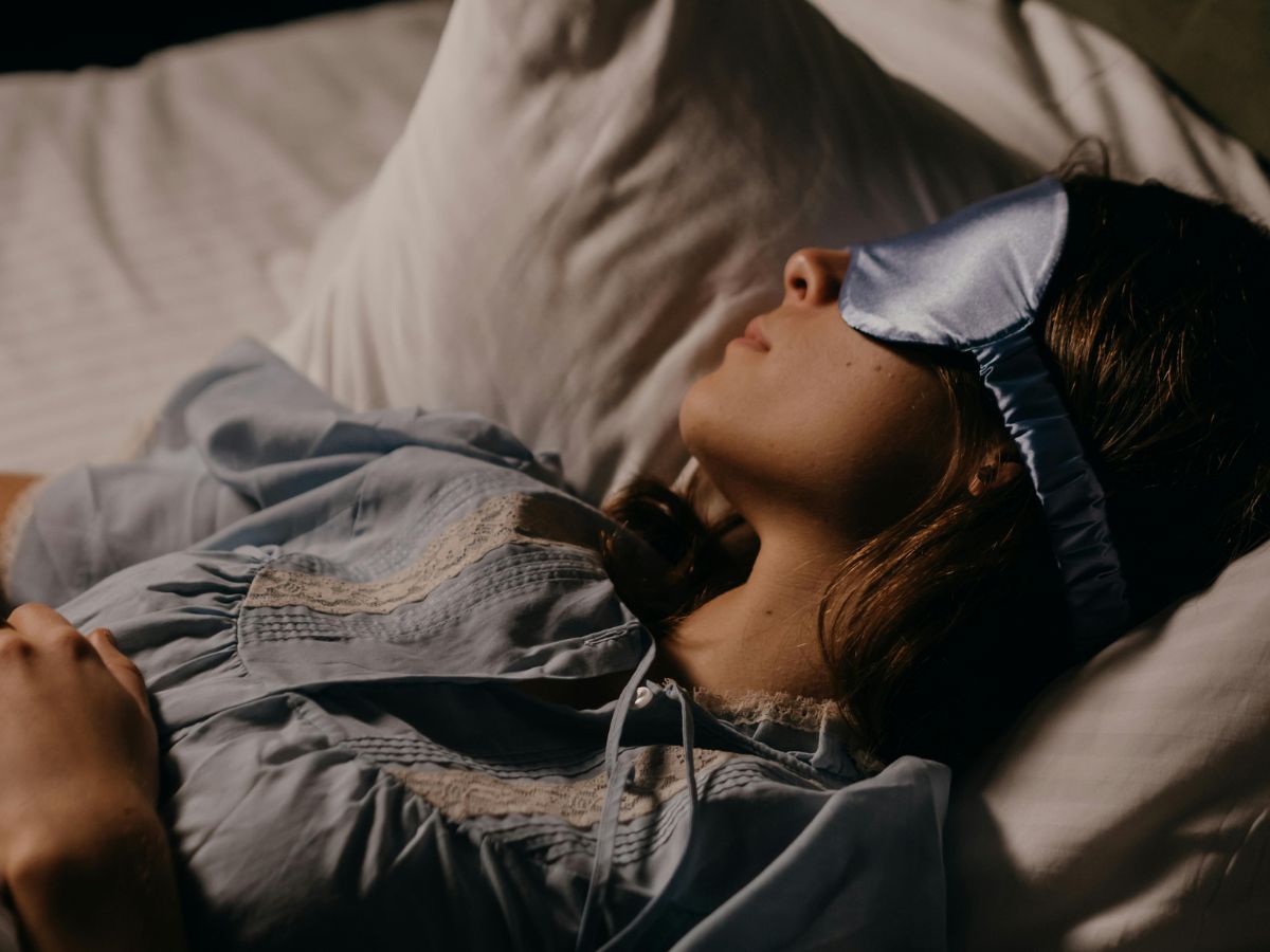 person resting with an eye mask