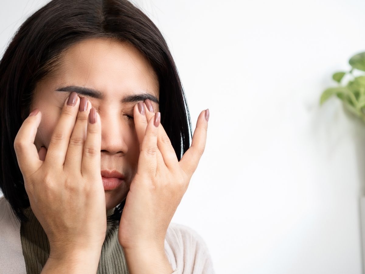 woman rubbing her eyes